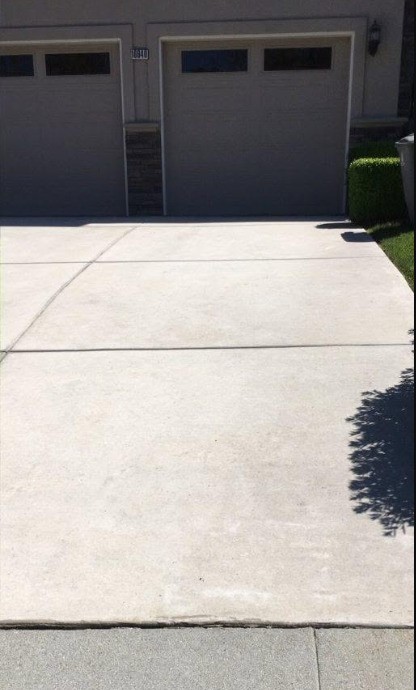 The same driveway uniform and clean after pressure washing