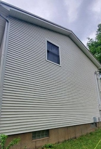 The same siding bright and clean after a soft wash